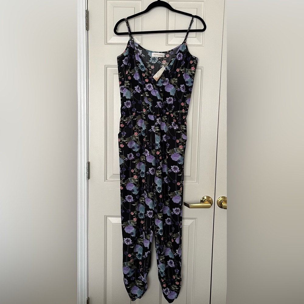 Kittenish black and floral spaghetti strap jumpsuit with pockets.